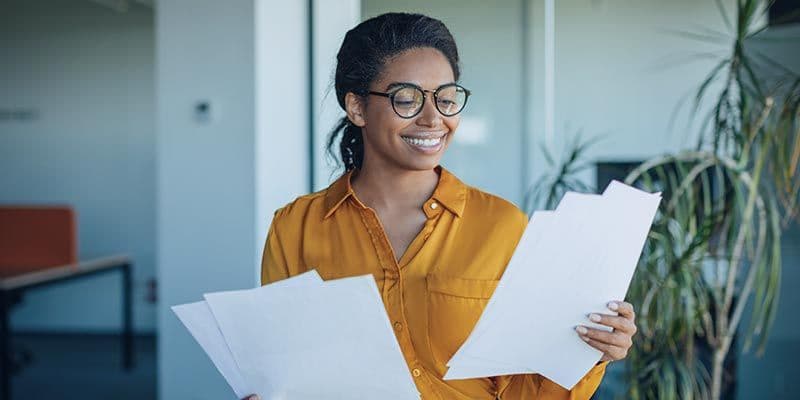 Woman reading audiometer calibration certificates